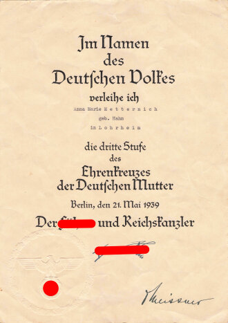 Ehrenkreuz der Deutschen Mutter dritte Stufe mit Verleihungstüte, diese mit Hersteller Louis Gottlieb & Söhne gestempelt, dazu  die zugehörige Verleihungsurkunde für eine Frau aus Lohrheim