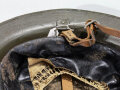 U.S. Modell 17 steel helmet. Original liner and chin strap, most likely used in the 20/30´s reused with new paint