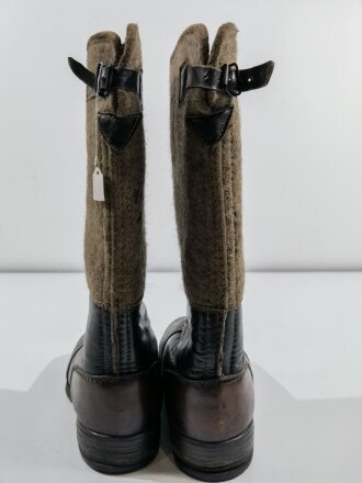 Paar Winterstiefel Wehrmacht, Filz mit geschwärztem Leder, im Zugbandinneren Reichsbetriebsnummer, eine Stiefelsohle mit Loch vom aufstellen einer Schaufensterfigur