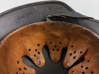 Stahlhelm Modell 1940 der Wehrmacht. Originales Innenfutter, Nieten und Glocke Q66. Neuzeitlich lackiert und mit Emblemen der Polizei versehen, der Kinnriemen ist ebenfalls eine Reproduktion.