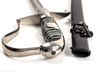 " Kavallerie Regiment 18"  Säbel von Eickhorn Solingen mit beidseitig geätzter Klinge. Sehr seltene Ausführung mit zwei Adlern. Die Klinge in sehr gutem Zustand, die Scheide original lackiert mit diversen Altersspuren, die Griffwicklung teilweise defekt.