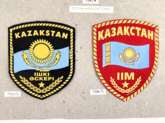 Kasachstan, Sammlung 6 Abzeichen Polizei und Militär, auf Karton getackert