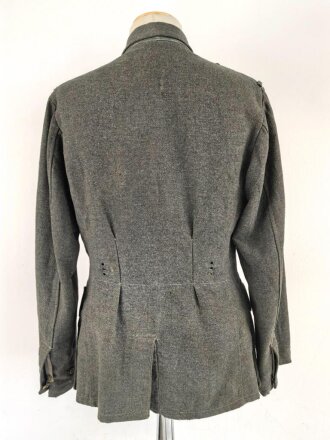 Heer, Feldbluse für Mannschaften Modell 1943. Kammerstück aus italienischem Tuch . Die Kragenspiegel höchstwahrscheinlich original vernäht, der Brustadler ergänzt. Stark getragenes Stück mit diversen älteren Reparaturstellen.