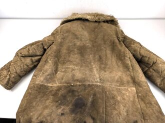 Schwerer Wintermantel mit großen Kastenstempel, dieser erinnert an russische Stempel. Gewaltige Grösse, riecht nach altem Fell und Keller.