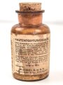 Glasflasche "Hautentgiftungssalbe" datiert 1943. Gesamthöhe 9,5cm