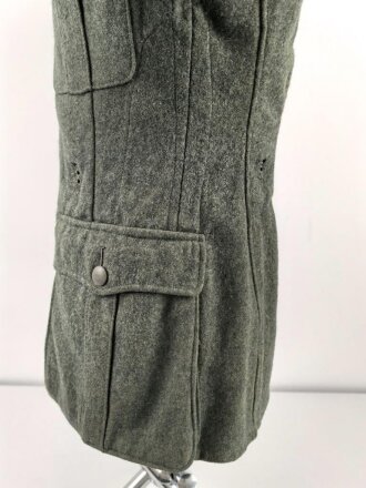 Heer, Feldbluse Modell 1940 für einen Obergefreiten der Kraftfahrtruppe. Leicht getragenes Kammerstück von 1941 . Die Kragenspiegel maschinenvernäht, der Brustadler von Hand. Im Rückenbereich diverse kleinere Schäden, sonst gut