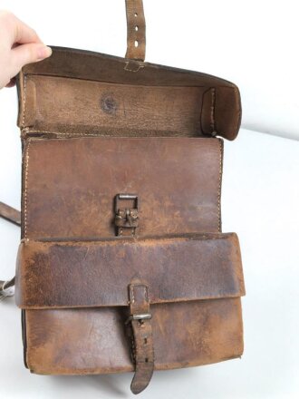 Lederne Tasche mit zwei Fächern, an Trageeriemen. Maße 22 x 24cm