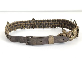 British most likely WWII , 12 cap badges attached to hand...