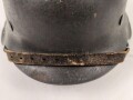 Heer, Stahlhelm Modell 1942. In allen Teilen original , das Innenfutter vermutlich in der Zeit gewechselt, früher Kinnriemen ergänzt, das Hakenkreuz vollständig erhalten. Hersteller EF 64. Ungereinigt