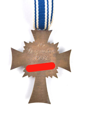 Ehrenkreuz der Deutschen Mutter in bronze, an langem Band. Nicht verausgabtes Stück, aus altem Bestand eines höchstwahrscheinlich Österreichischen Herstellers.