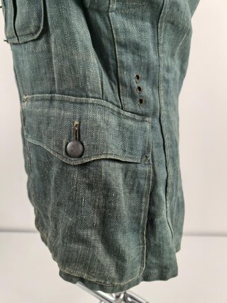 Feldbluse in Drillichmaterial. Heeresschnitt, aber eher Polizeigrünes Material. Weder Brust- noch Ärmeladlerabdruck, dafür deutliche , relativ große Kragenspiegelabdrücke. Getragenes Kammerstück