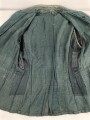 Feldbluse in Drillichmaterial. Heeresschnitt, aber eher Polizeigrünes Material. Weder Brust- noch Ärmeladlerabdruck, dafür deutliche , relativ große Kragenspiegelabdrücke. Getragenes Kammerstück