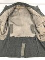 Heer, Feldbluse für Mannschaften Modell 1943. Getragenes Stück, die Kragenspiegel originalvernäht, der Brustadler könnte alt ergänzt sein, Kammerstempel siehe Foto