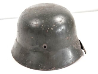 Heer, Stahlhelmglocke Modell 1935. Apfelgrüner, gedunkelter Originallack, das Hakenkreuz zu etwa 80% erhalten. Am Rand mit Splitterschaden. Ungereinigtes Stück, kein Hersteller erkannbar, Glockengrösse 66.