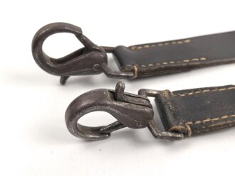 Lederriemen geschwärzt, lackierte Eisenschliesse, eiserne Karabinerhaken, Breite knapp 3cm, Länge etwa 125cm, Alter und Herkunft unbekannt