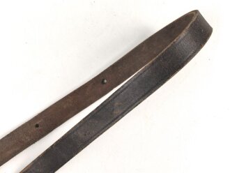 Lederriemen geschwärzt, lackierte Eisenschliesse, eiserner Karabinerhaken, Breite knapp über 2cm, Länge etwa 90cm, Alter und Herkunft unbekannt