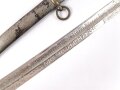 Kaiserreich, Klinge mit Scheide  für einen Säbel. Beidseitige Ätzung und Geschenkwidmung " ...zur freundlichen Erinnerung Juni 1896" zum Teil narbig , vermutlich neuzeitlich nachvernickelt. Klingenlänge 85cm. Dazu eine passgenaue Scheide