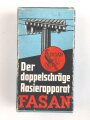 "FASAN" Rasierapparat aus transparenter Preßmasse. Ungebraucht, in der originalen Umverpackung, diese leicht zerdrückt