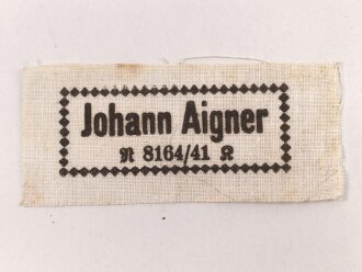 Wäscheetikett des Johann Aigner. Maße 3 x 7cm