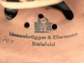 Leichtmetallhelm Feuerwehr III.Reich. Nach dem Krieg überlackiert und mit Nachkriegsinnenfutter versehen. Das eine Abzeichen noch unter dem Lack vorhanden und teilweise sichtbar, das andere wohl entfernt.