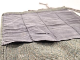 Stück grünmelierter Stoff samt Innefutterstoff von einem "Knochensack" der Fallschirmjäger. Sicherlich nach dem Krieg zu einer Werkzeugrolle umgebaut. Maße 22,5 x 28cm