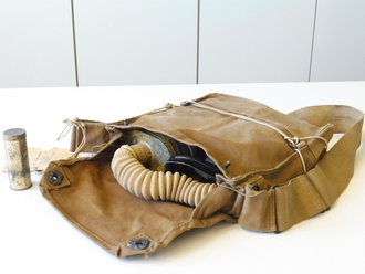 U.S. Army WWI, Gas mask in bag, Mask is soft, tube dry. Comes in a 1917 dated bag with anti-dimming compound and Instruction book. Issued to a Machine Gun member of 26. Infantry Div. on 21. Aug.1918 so he could have been in the Battle of Saint-Mihiel