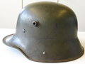 1. Weltkrieg, feldgrauer Stahlhelm. Originallack und Innenfutter. Zusammengehöriges Stück, durch das Schrumpfen des Lederrings wackeln die Nieten